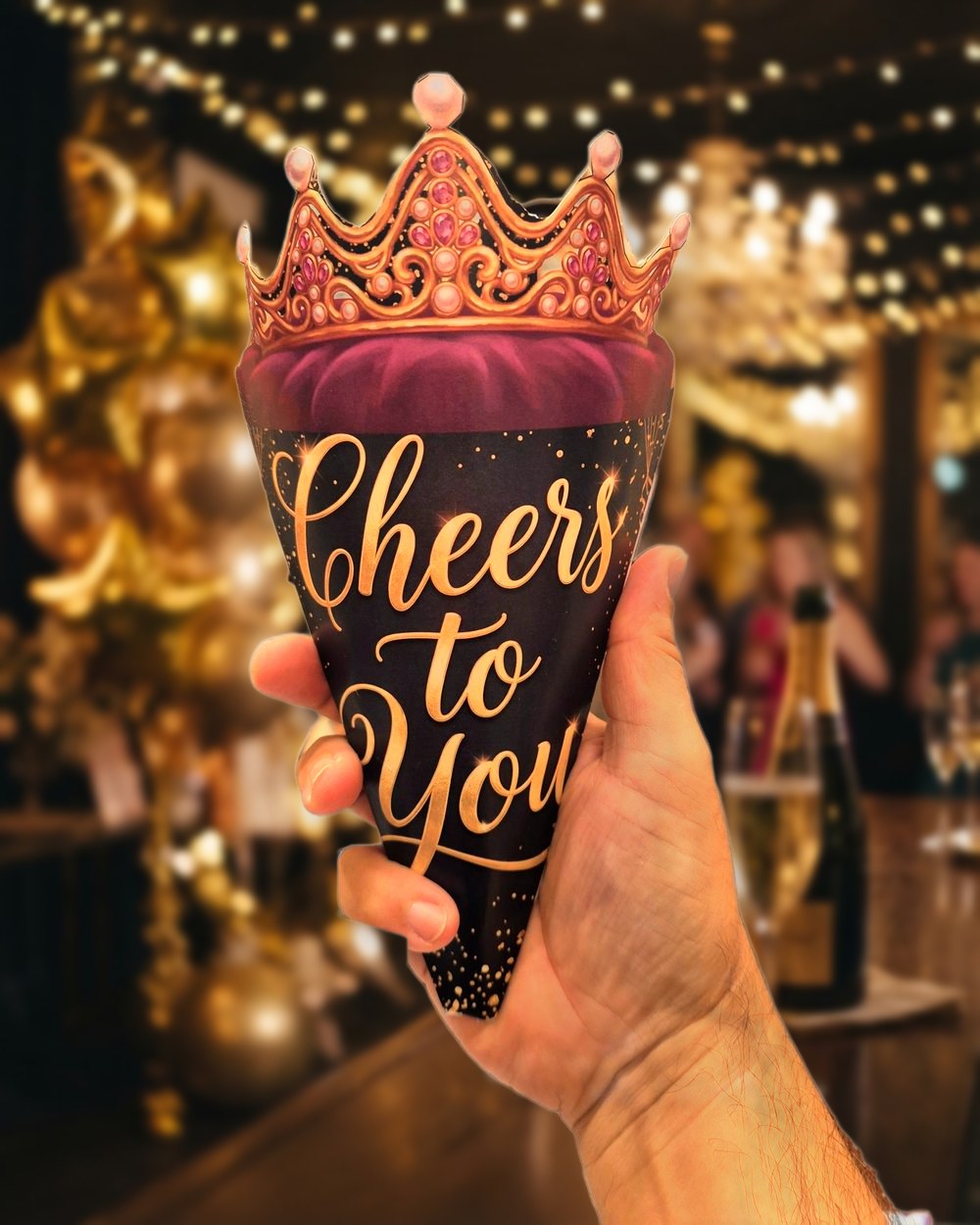 A Cheers to You cone with a jewelled crown